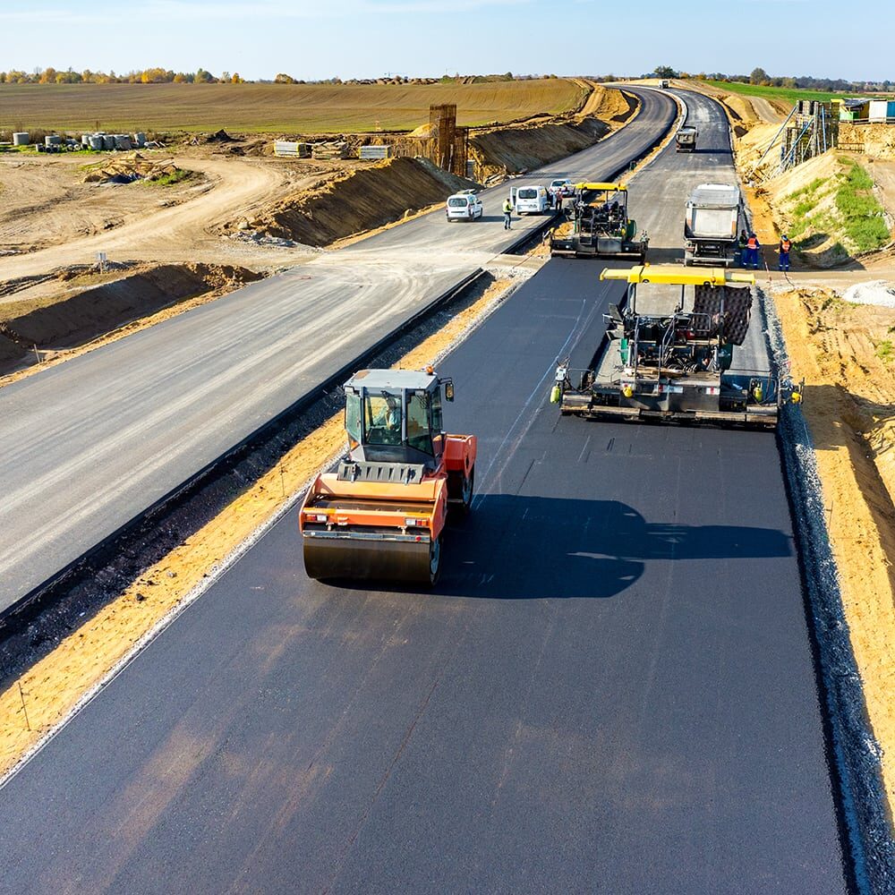 Aerial view on the road rollers building the new asphalt road